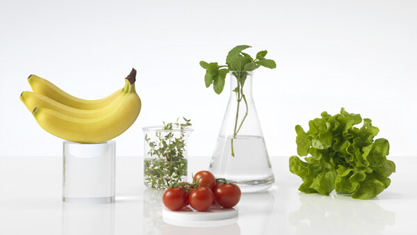 Fruits et légumes frais sur un comptoir blanc dans des béchers en verre