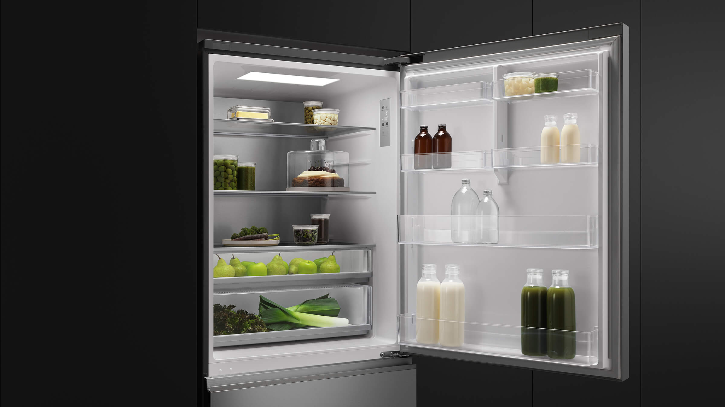 Interior of a bottom freezer refrigerator showing organized storage of fresh produce and beverages