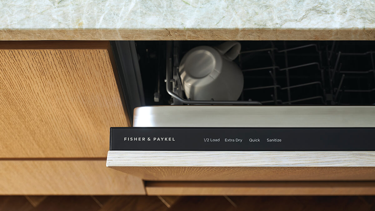 Detail shot of a slightly ajar drop down dishwasher.