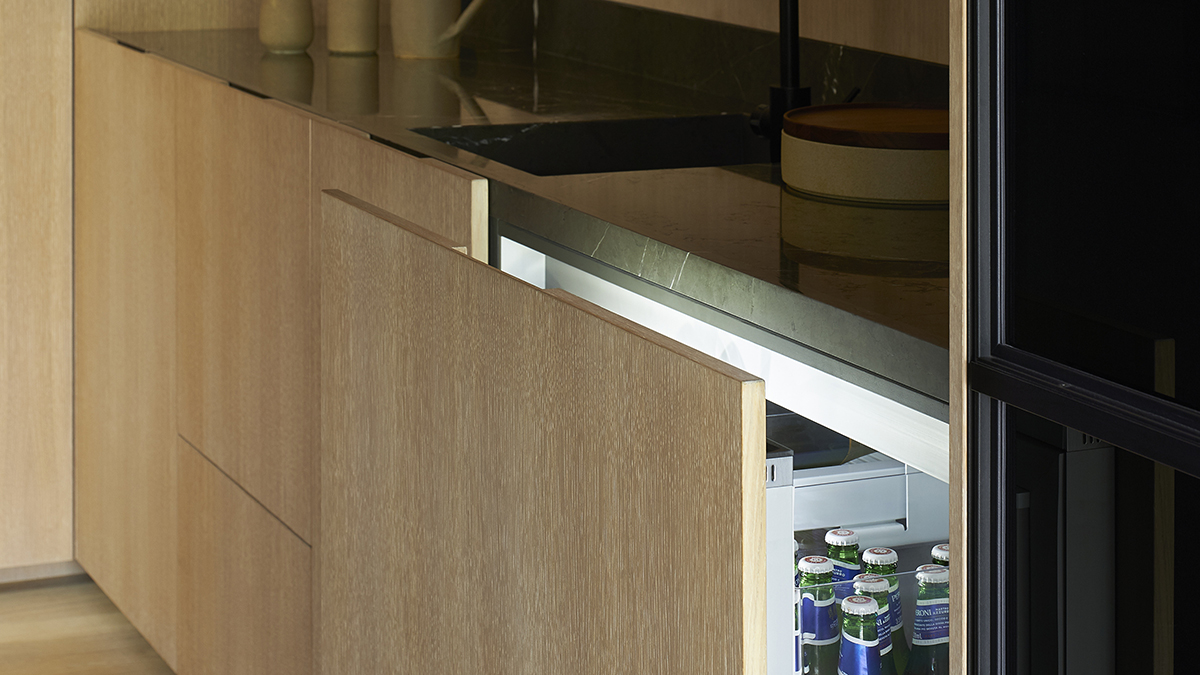 a Fisher & Paykel CoolDrawer™ slightly open revealing beer bottles