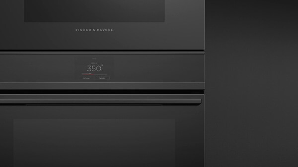 Front View of a Black Minimal Style Microwave Oven atop a Matching Oven Seamlessly Framed by a Trim Kit.