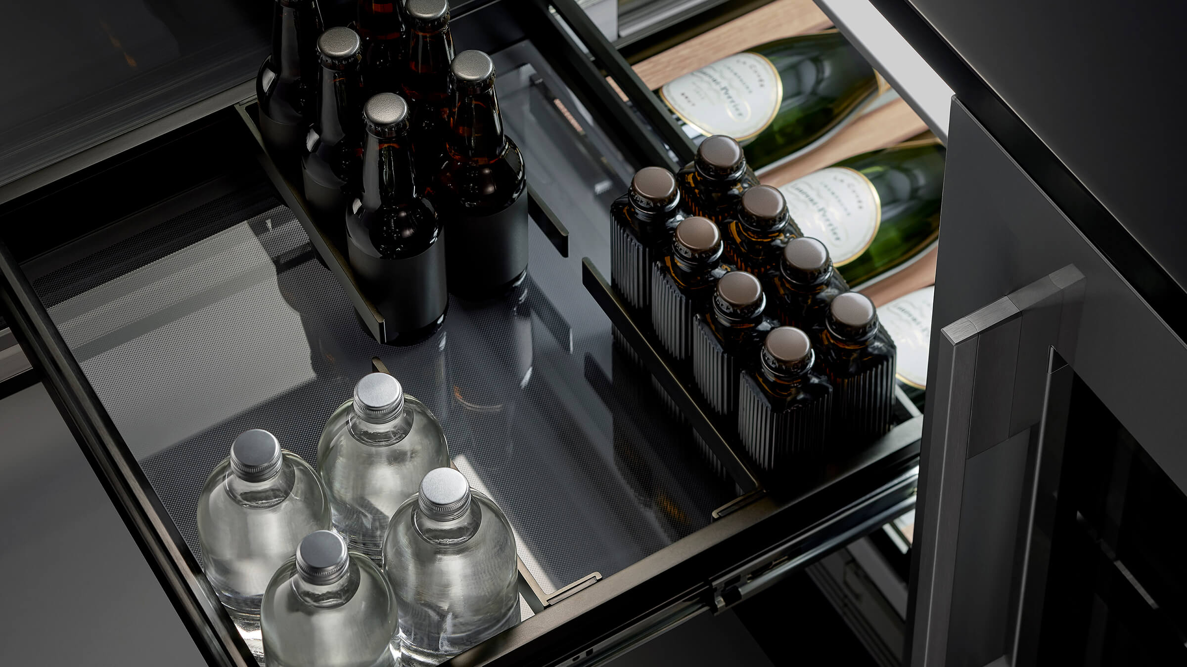 A black stainless steel Quad Door refrigerator with recessed handles, designed for effortless use