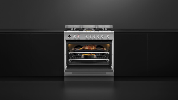 Combination of a Conventional and Steam Oven in Black with Silver Detailing Set into Black Cabinetry.