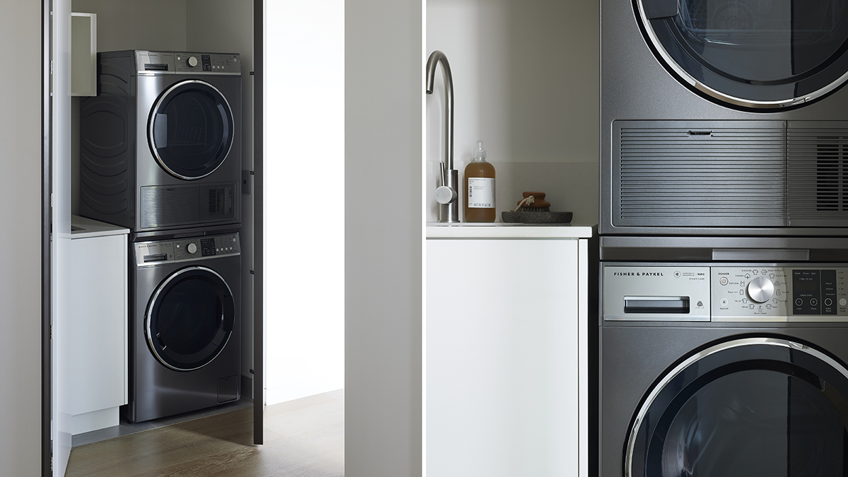 The laundry room showcases the perfect pair; dark washing machine and dryer stacked vertically.