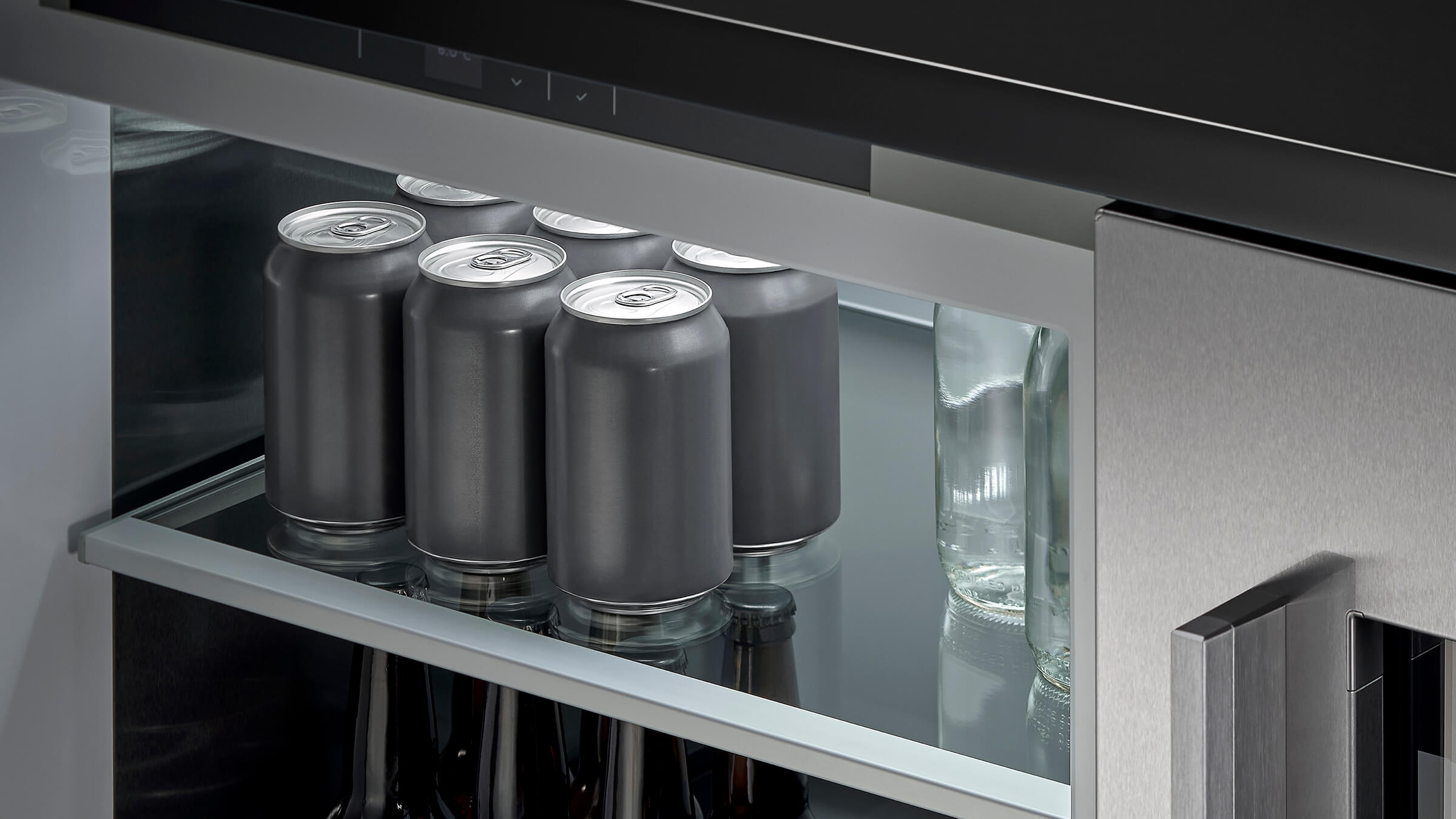 Cans in an undercounter refrigerator, ready to serve