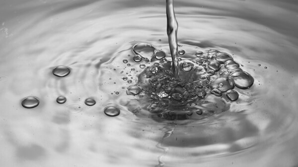 Water Pouring on a Rippling Surface of Water