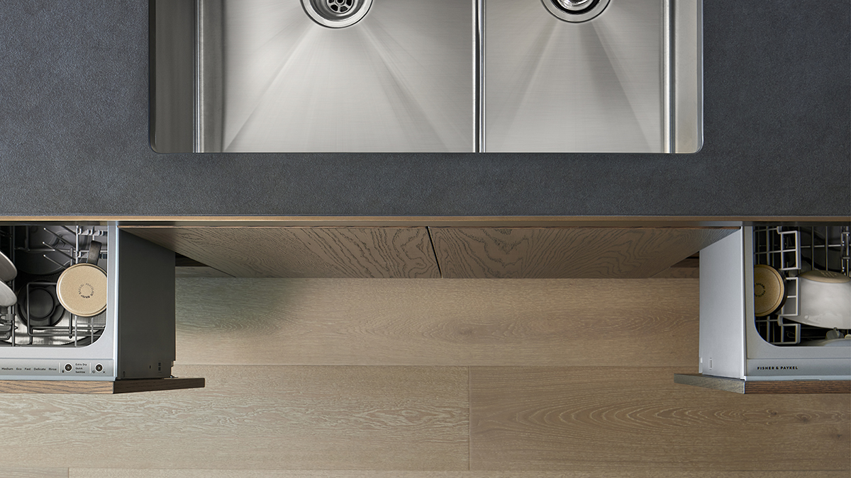 A birds-eye view of the kitchen sink, with DishDrawer™ Dishwashers opened slightly on either side of the sink.