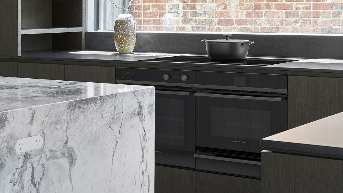 Close up of the kitchen focusing on the minimal ovens and cooktop