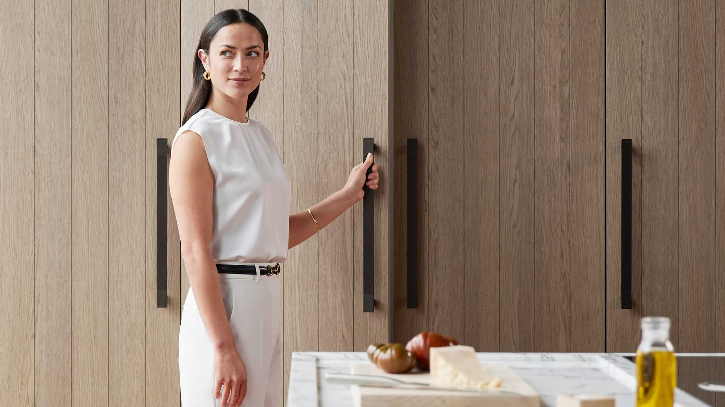 Clean lines of integrated refrigeration columns in an open-plan contemporary kitchen