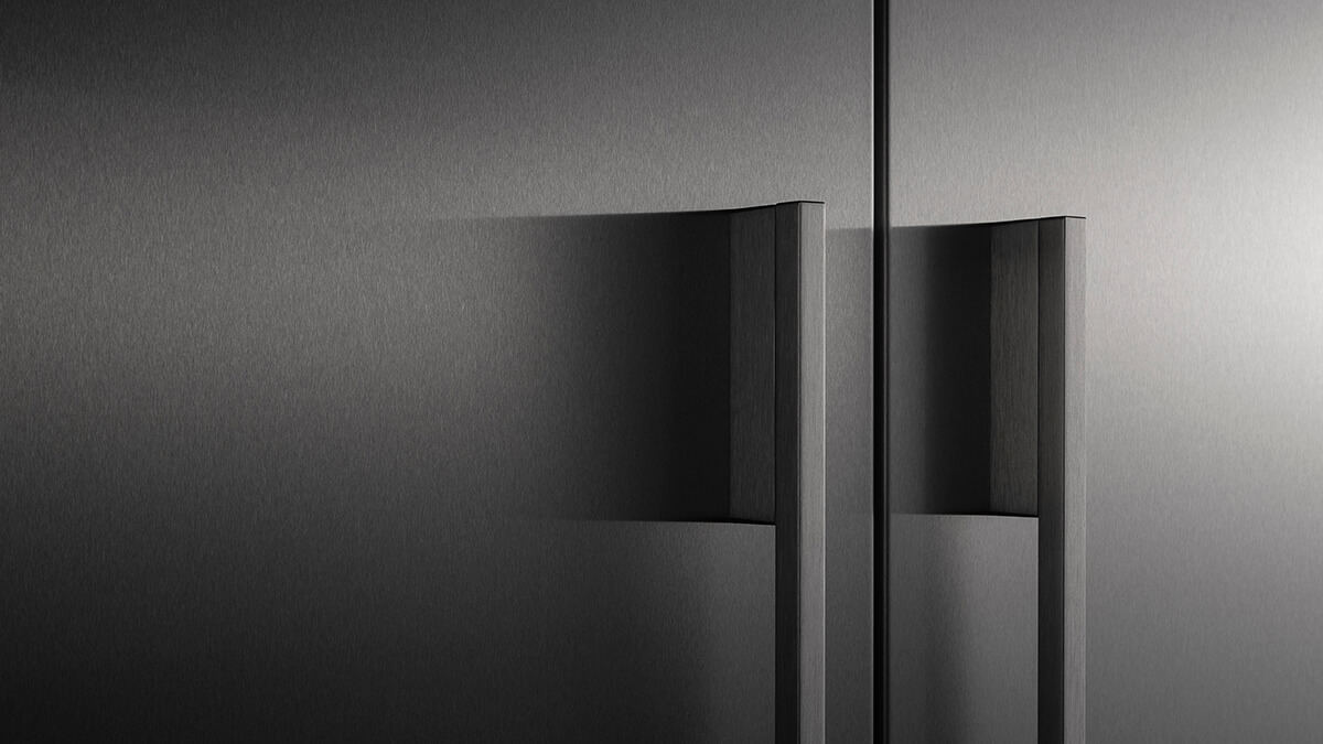 Close-up of a sleek, contemporary door handle on a stainless steel appliance