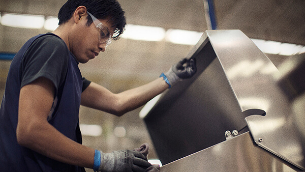 Fisher & Paykel engineer inspecting a DCS Grill.