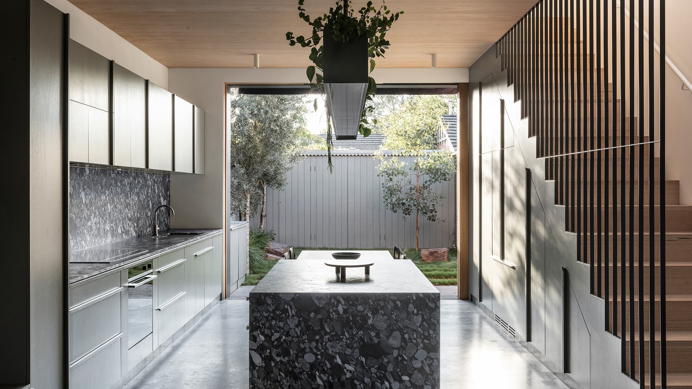 View from living area to the kitchen and dining space heading to the courtyard