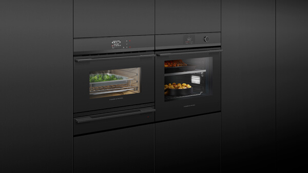 Combination of a Conventional and Steam Oven in Black with Silver Detailing Set into Black Cabinetry.