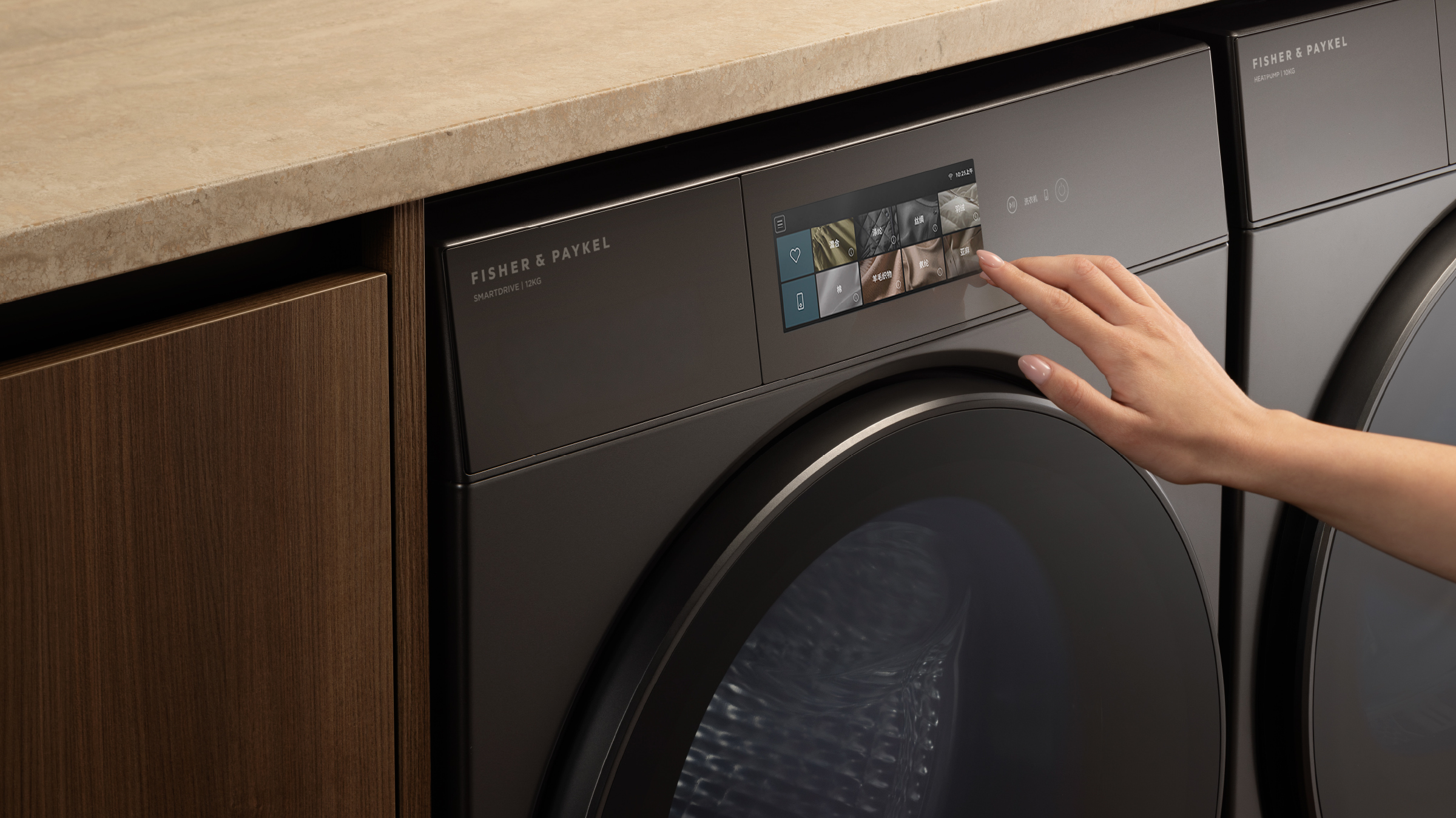 Hand selecting a cycle on the touch control of a Fisher & Paykel laundry appliance