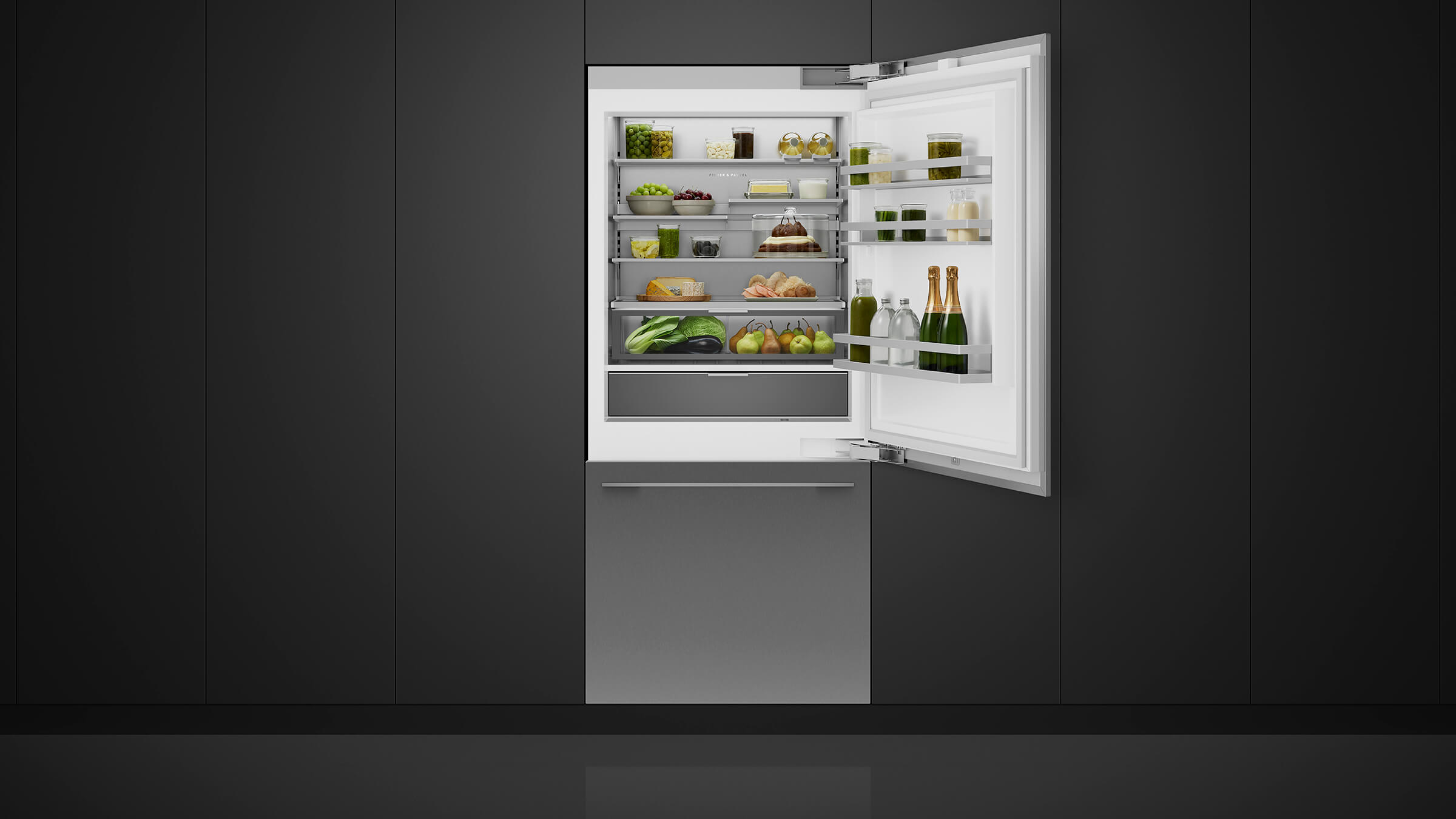Open view of an integrated bottom freezer refrigerator showing a well-organized interior