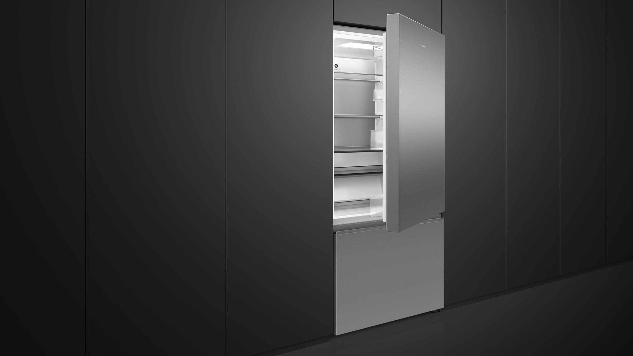 A stainless steel bottom freezer refrigerator in a contemporary kitchen setting