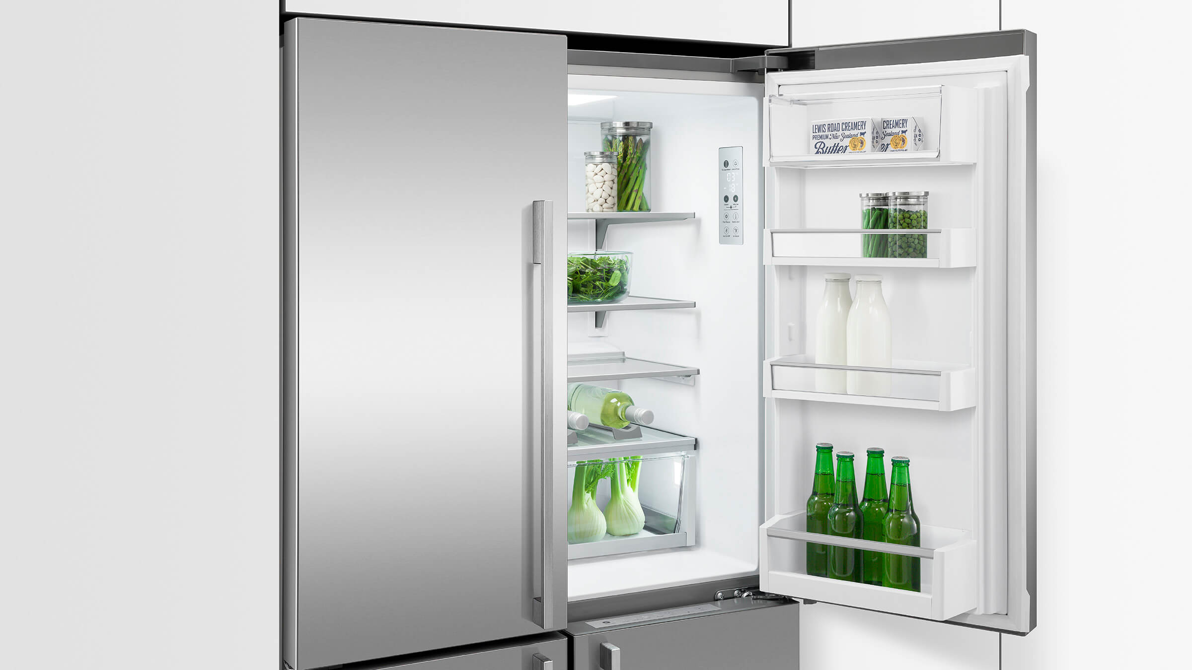 Contemporary French Door refrigerator integrated into a light-colored kitchen design
