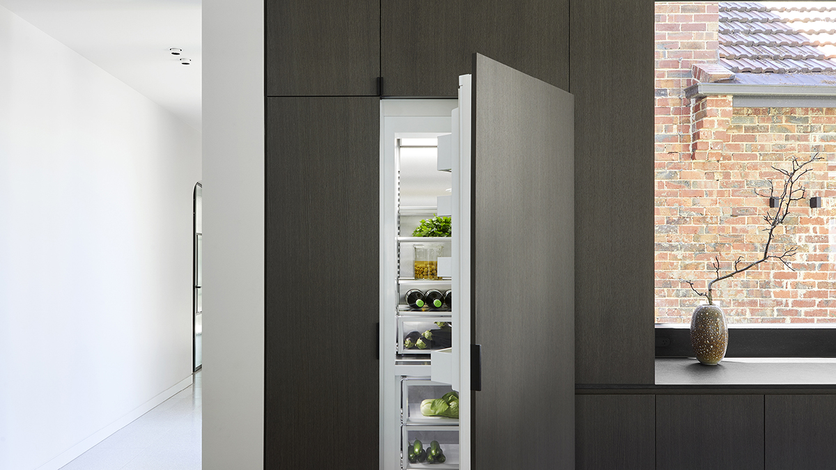 Close up of the integrated refrigerator and freezer. The refrigerator door is ajar.