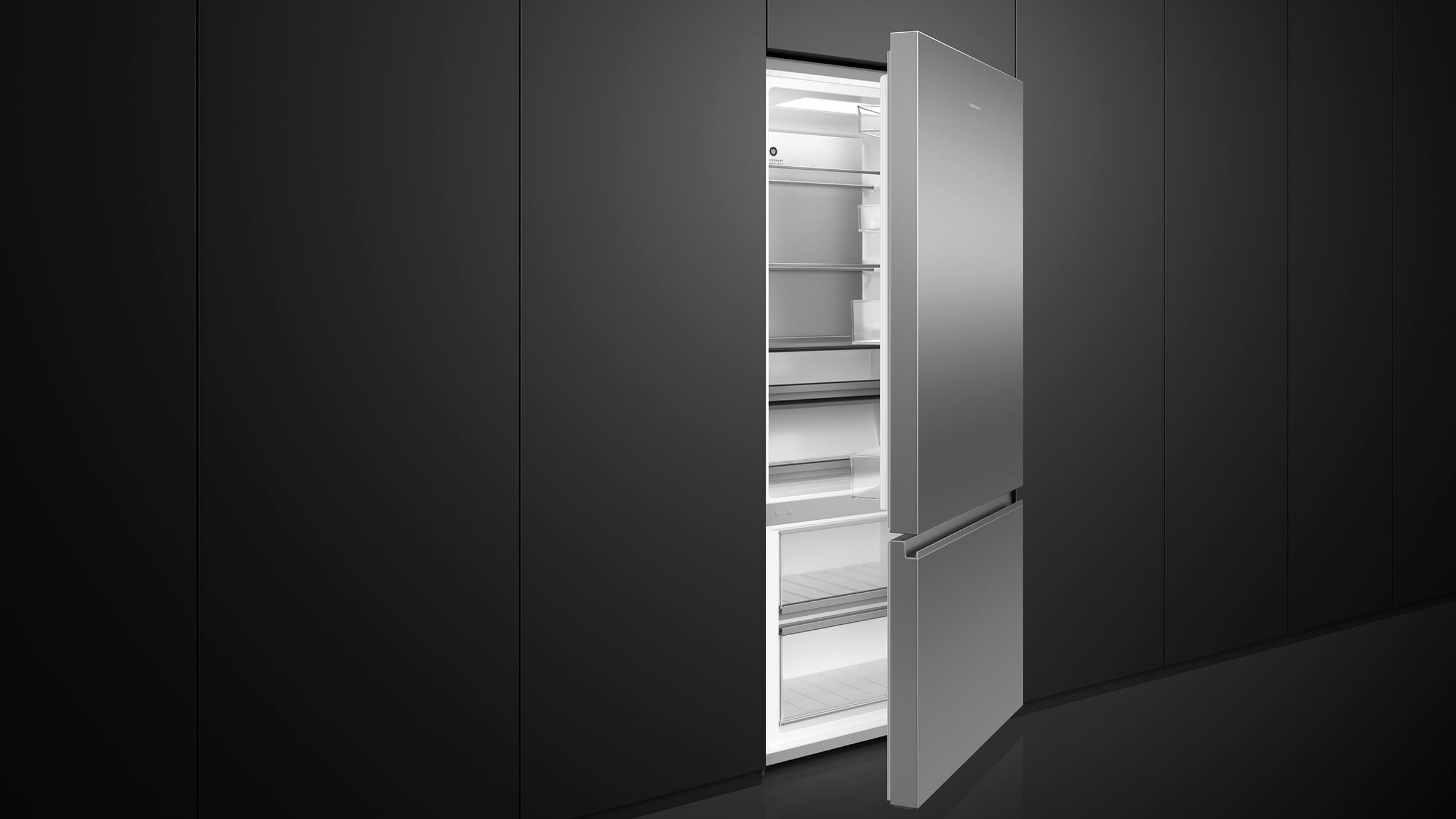 Elegant stainless steel bottom freezer refrigerator integrated into a light-colored kitchen design