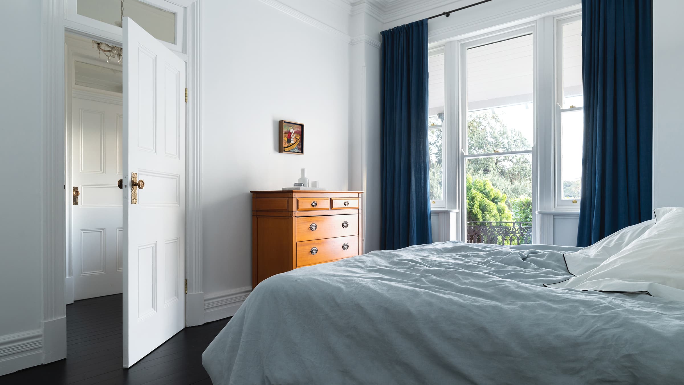 Master bedroom showing grey cabinetry with a view into the ensuite bathroom