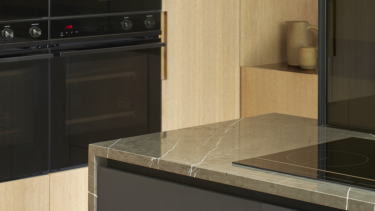 looking from the induction cooktop on a marble surface towards the minimal oven