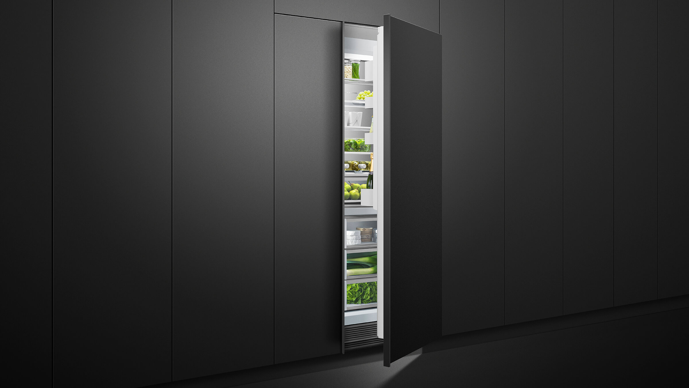 A trio of integrated refrigeration columns—freezer, refrigerator, and wine column—in a dark cabinetry wall