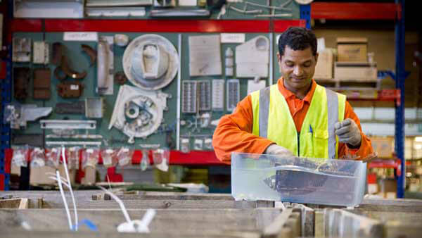 Technician Conducting Tests in Workshop.