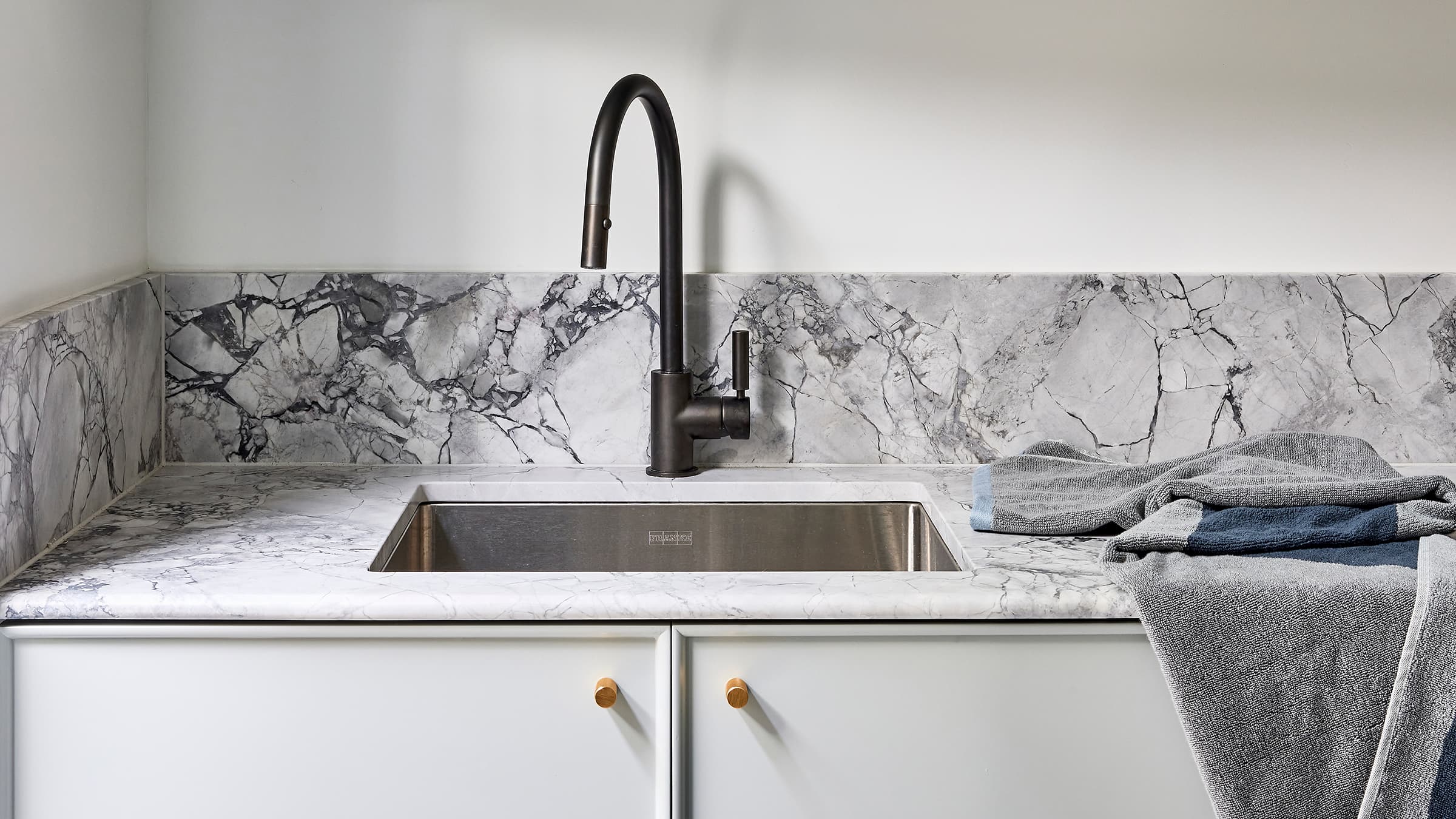 View of marble textured slab with white cabinetery