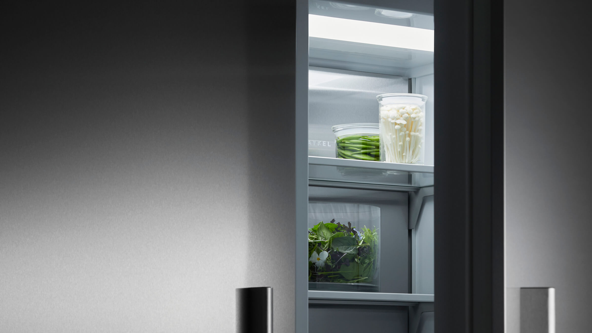A bright, well-lit interior of a vertical refrigerator showing a full view of stored food