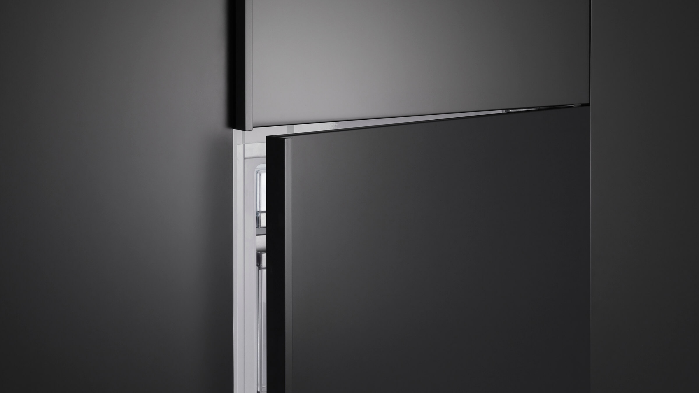 Detail of the flush installation and seamless panel-ready integration for bottom freezer refrigeration