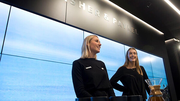 Two female Fisher & Paykel designers at a Retail Experience Expo.