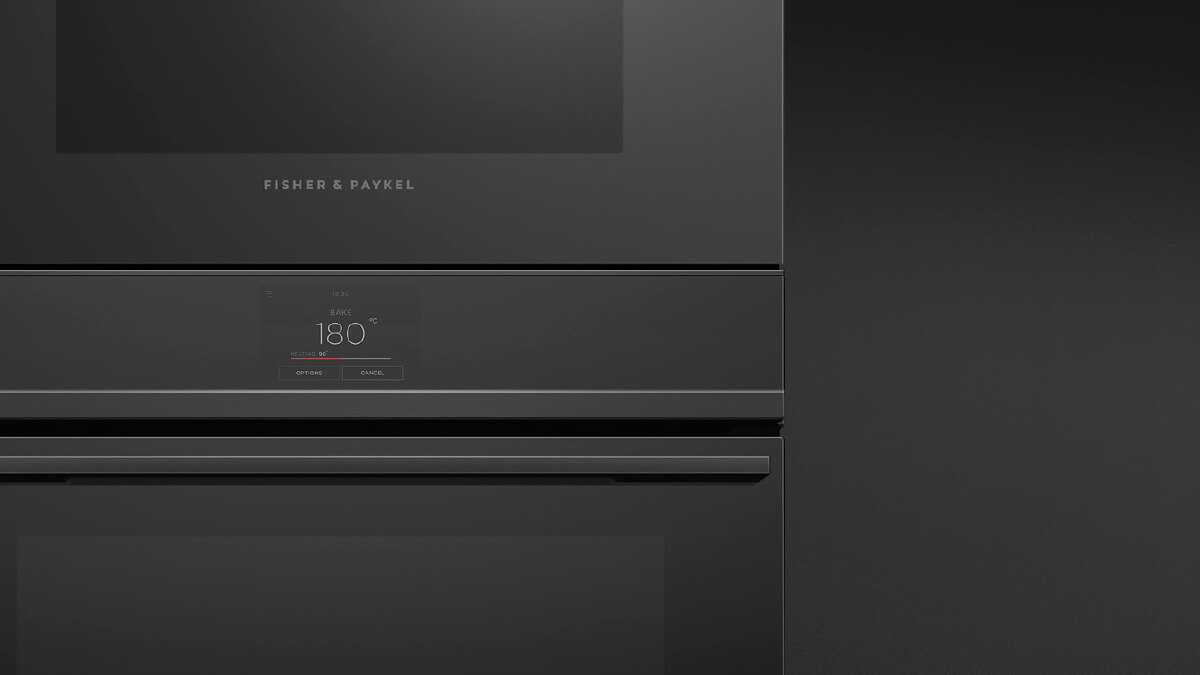 Front View of a Black Minimal Style Microwave Oven atop a Matching Oven Seamlessly Framed by a Trim Kit.