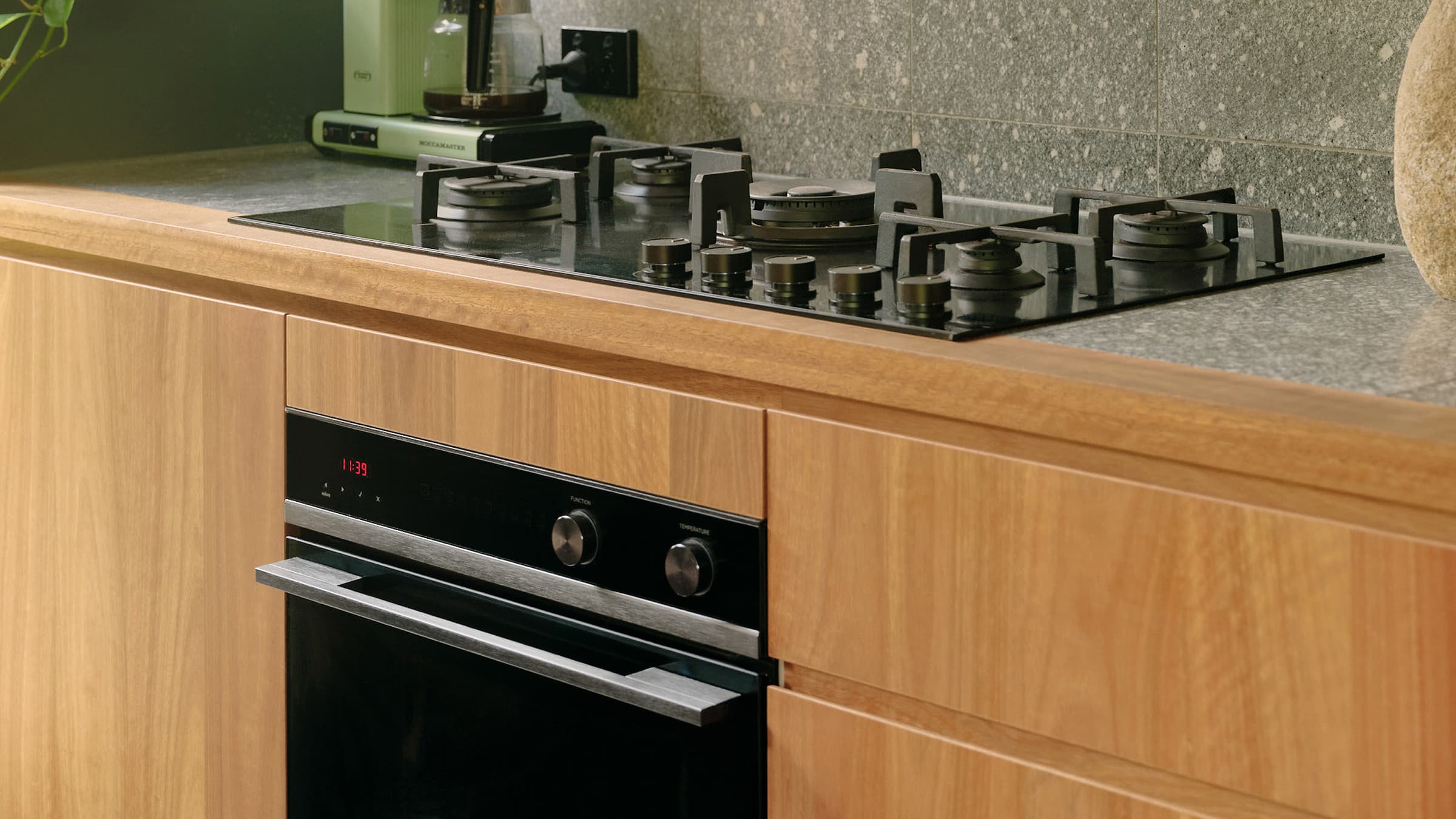 Front view of an open Integrated double DishDrawer dishwasher and the minimal contemporary cooktop