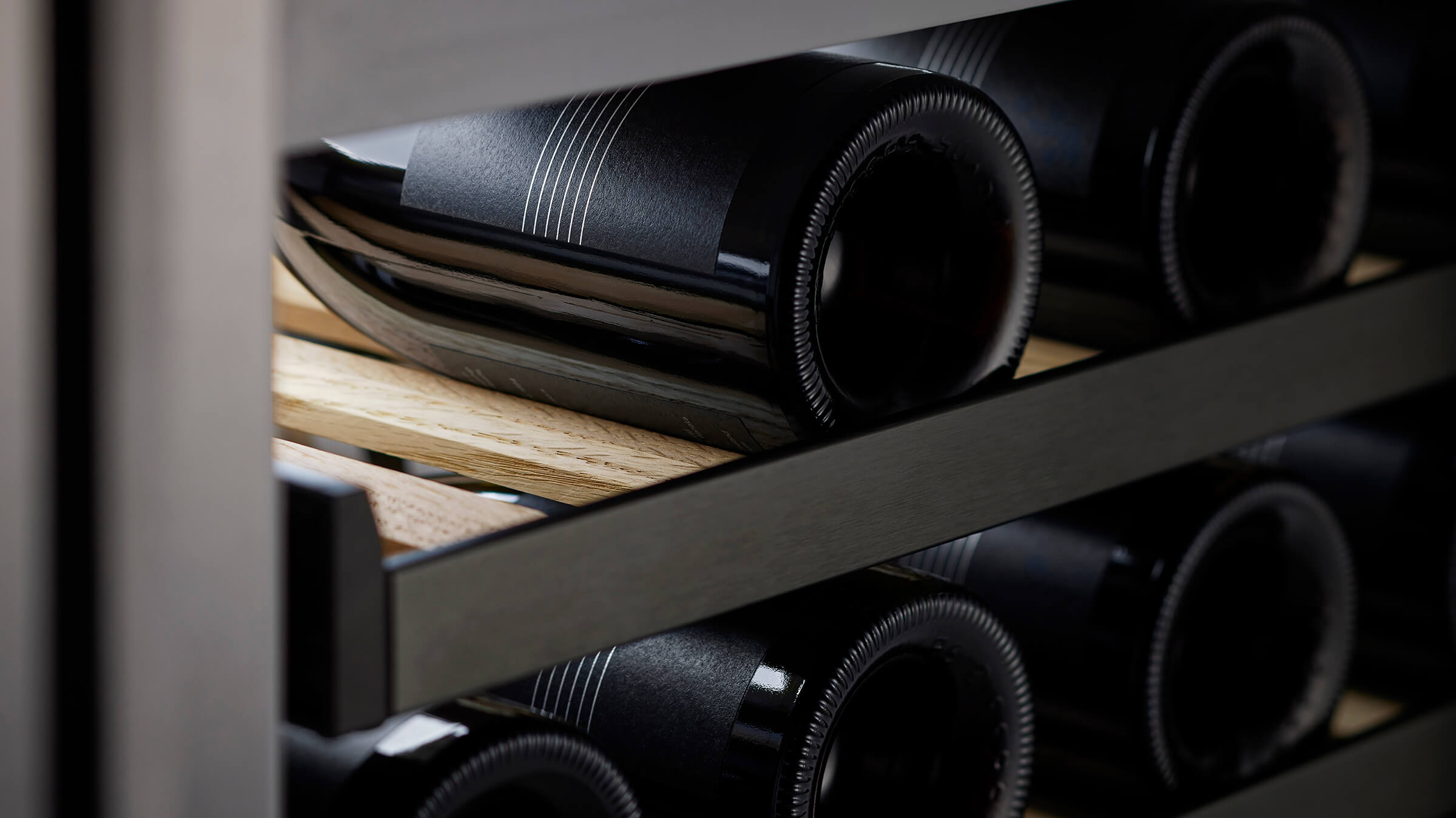Wine bottles on oak shelves for long-term cellaring
