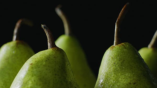 Fresh Fruit and Vegetables on a White Countertop in Glass Beakers