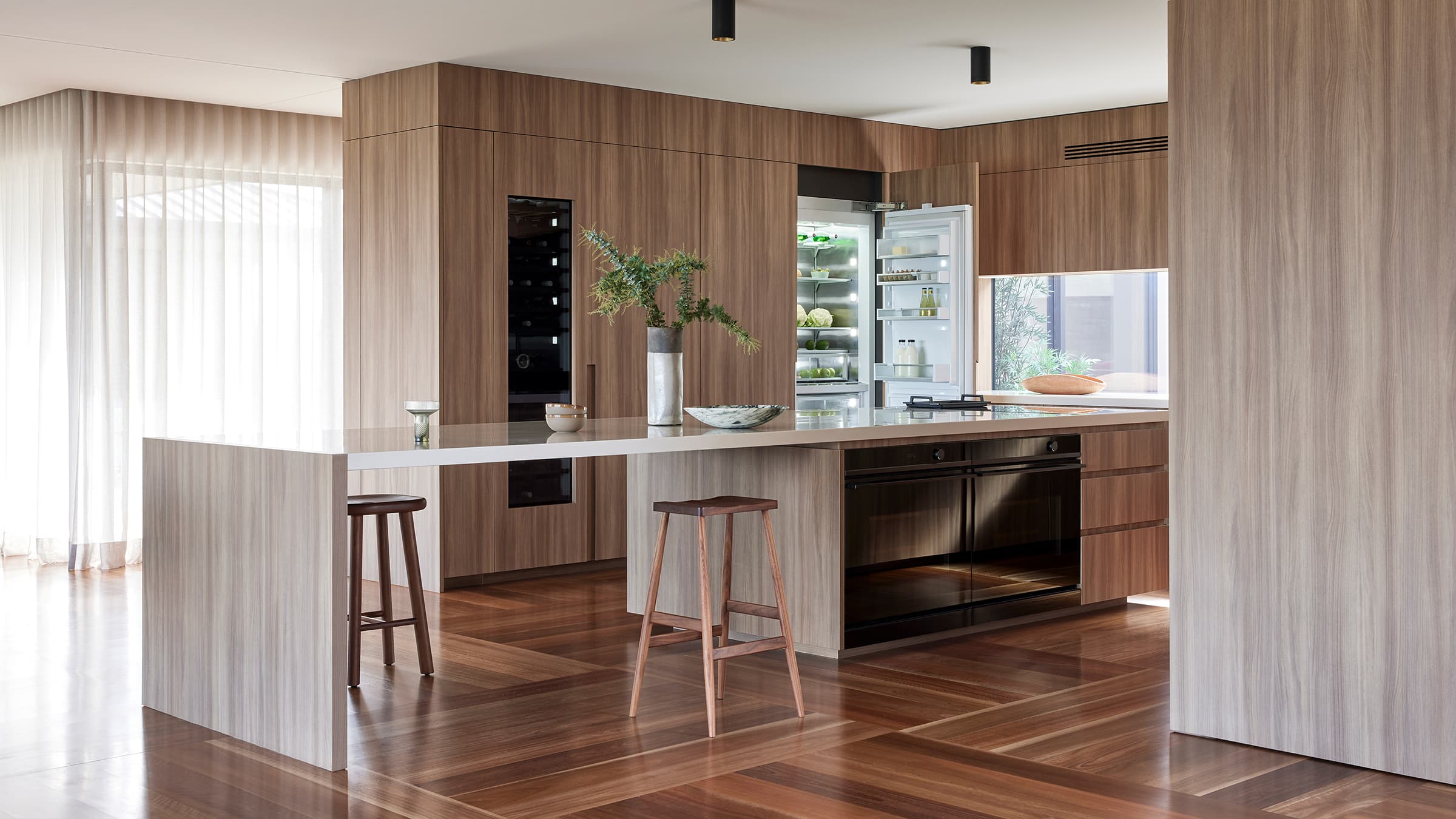 Shot of the kitchen, showcasing the Minimal Oven and Integrated Column Refrigerator with the door open.