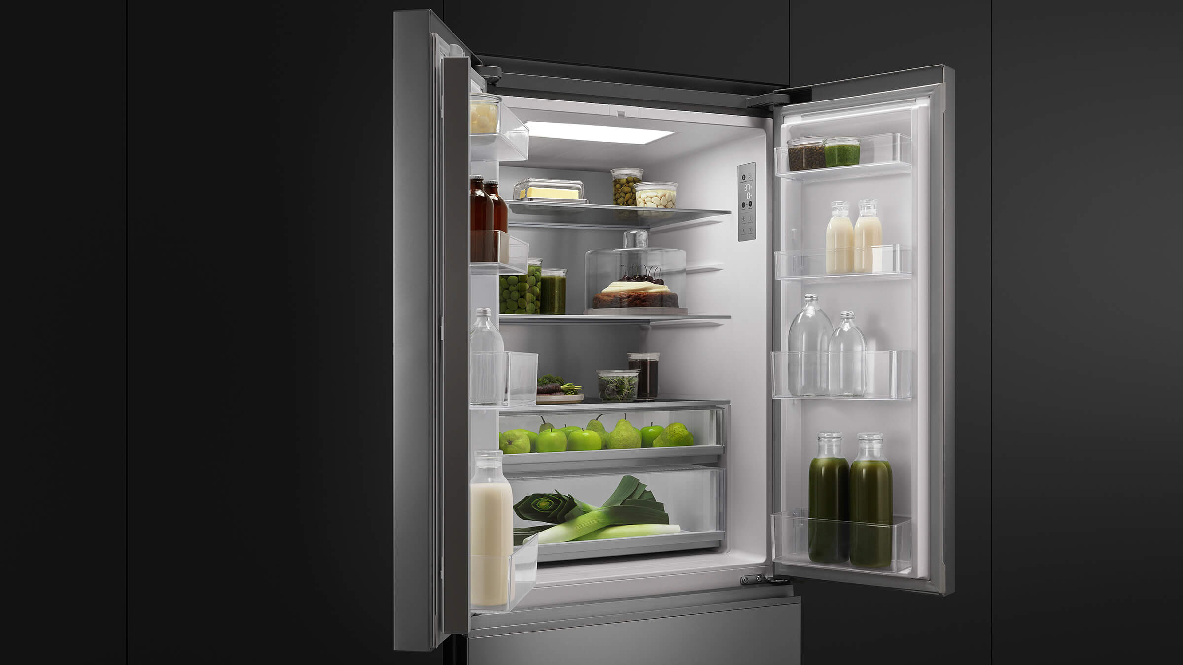 Interior of an open French Door refrigerator showing wide, organized shelving with fresh produce