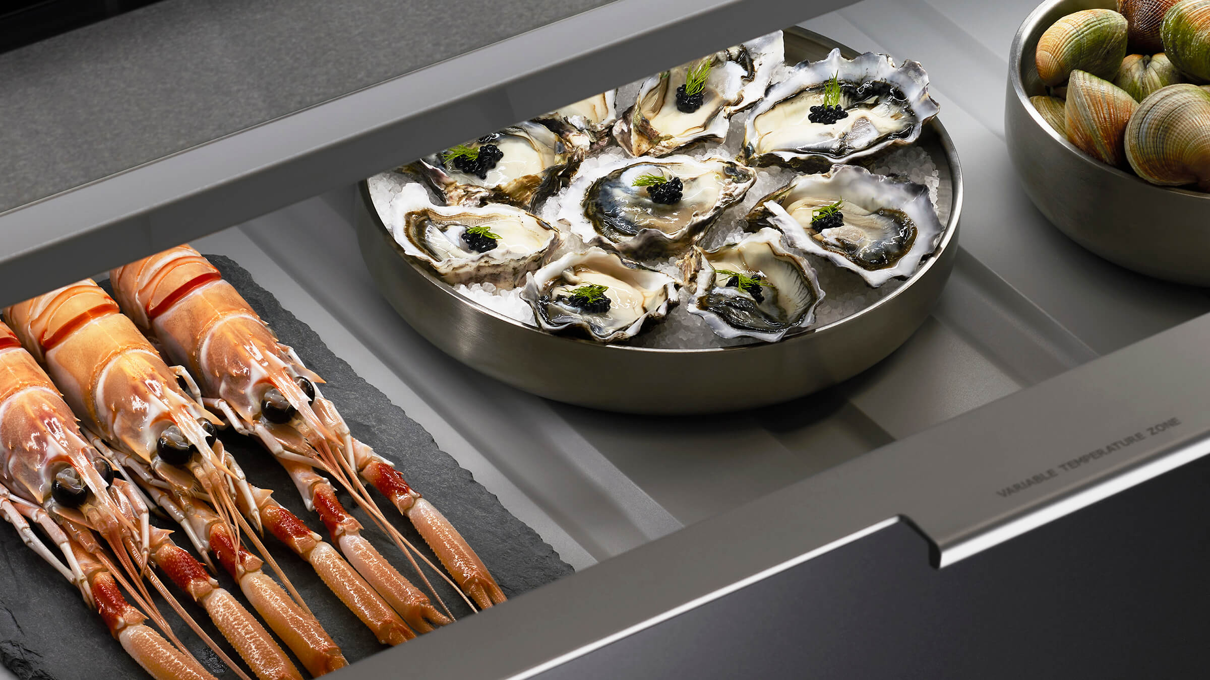 Empty variable temperature drawer showing the premium interior finish and glass dividers