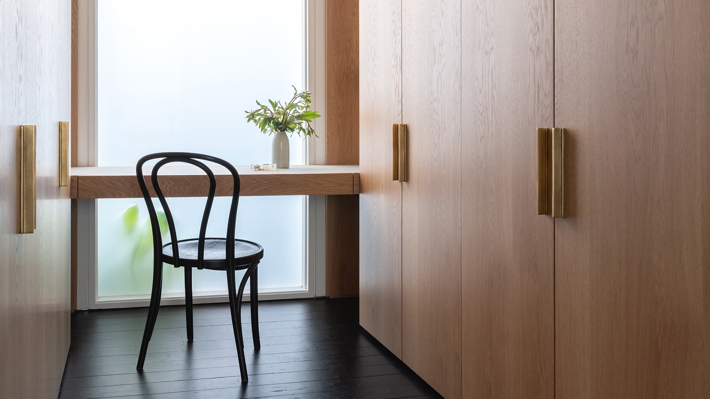 Master bedroom showing grey cabinetry with a view into the ensuite bathroom