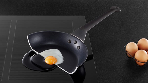 Close up of frying pan on induction cooktop with eggs